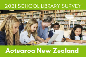 Students sitting down using the school library system at the library