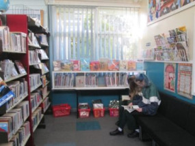 Students reading books in corner