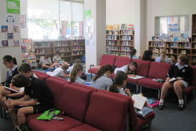 Group of students on lounge chairs in library