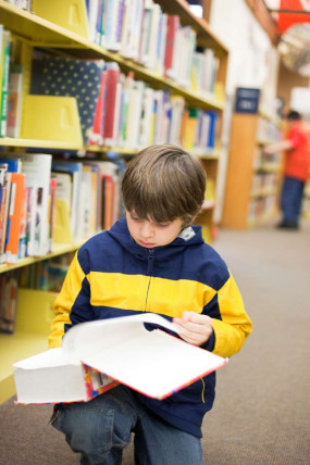 School child reading in their school library 