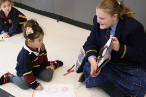 Year 6 student reading to juniors 3