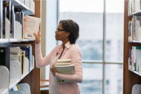 Teacher librarian selecting books